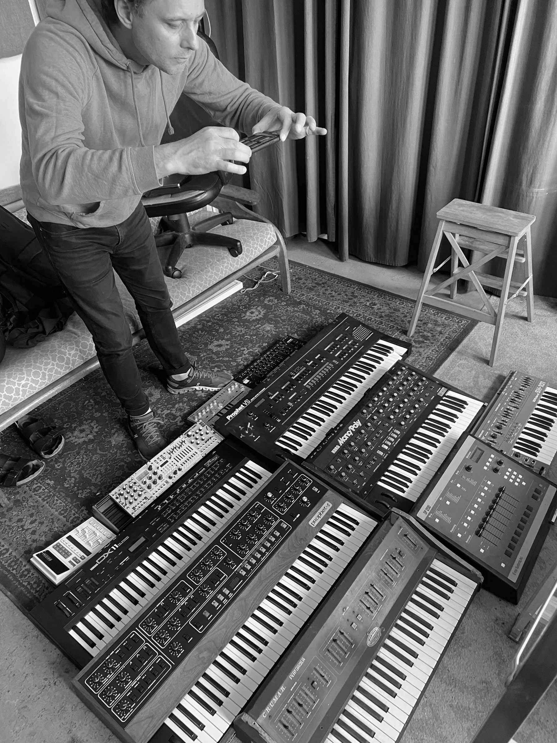 A photograph of James Paterson taking a photo of Stephen Ramsay's synthesizer collection